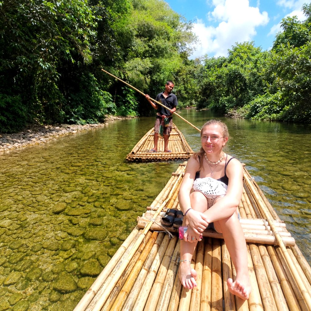 Guest enjoying a bamboo rafting experience on a tropical river in Khao Lak