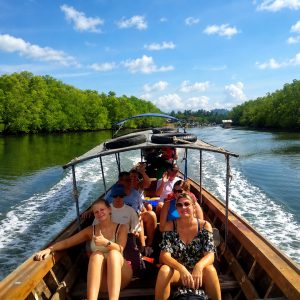 Guests travelling by longtail boat through mangroves in Phang Nga Bay