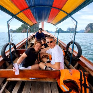 Passenger relaxing on a longtail boat in Phang Nga Bay