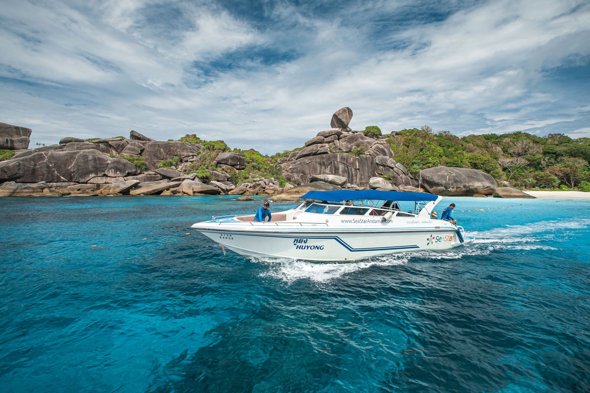 Speedboat cruising through clear blue water at the Similan Islands